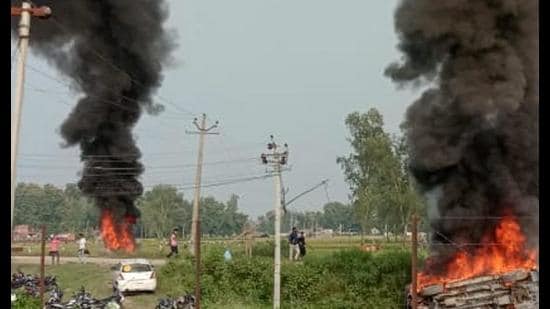 Vehicles set ablaze after a car hit protesting farmers at Lakhimpur Kheri on Sunday. (PTI)