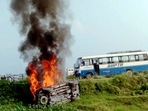 A vehicle is set ablaze after violence broke out following a farmers' protest in Lakhimpur Kheri. (PTI Photo) A vehicle is set ablaze after violence broke out following a farmers' protest in Lakhimpur Kheri. (PTI Photo)
