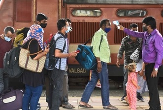 A BMC health worker checks temperatures before Covid-19 test of passengers arriving on outstation trains at Dadar station, in Mumbai ( Satish Bate/Hindustan Times) A BMC health worker checks temperatures before Covid-19 test of passengers arriving on outstation trains at Dadar station, in Mumbai ( Satish Bate/Hindustan Times)