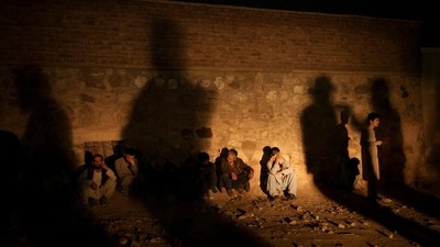 The shadow of Taliban fighters casts over drug users detained at a police station in Kabul. (AP)