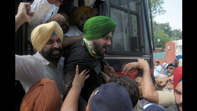 Punjab Congress president Navjot Sidhu along with party MLAs and workers being detained by police during a protest against the Lakhimpur Kheri incident outside the Punjab Raj Bhawan in Chandigarh on Monday.