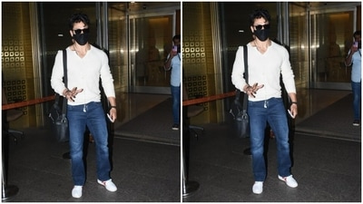 Tiger accessorised his look for the day with a leather sling bag and white sneakers with red borders. In tinted shades, the actor posed for the cameras outside the airport. (HT Photos/Varinder Chawla)