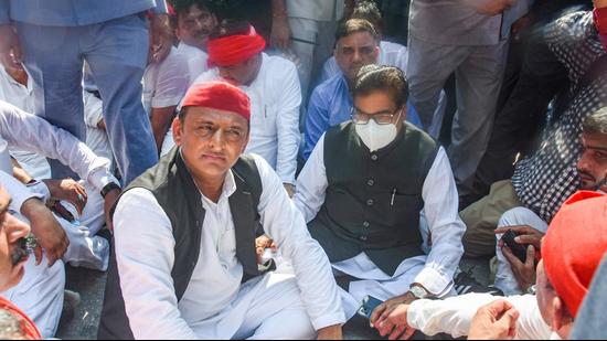 Samajwadi Party president Akhilesh Yadav along with party MP Prof Ram Gopal Yadav stage a protest, after he was not allowed by the police to go to Lakhimpur, in Lucknow, Monday. (PTI)