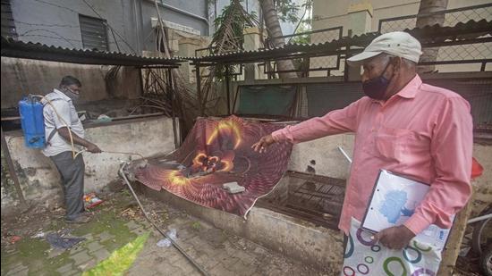 PMC workers spray mosquito repellent in a housing society amid rise in dengue cases in Pune. (HT Photo)