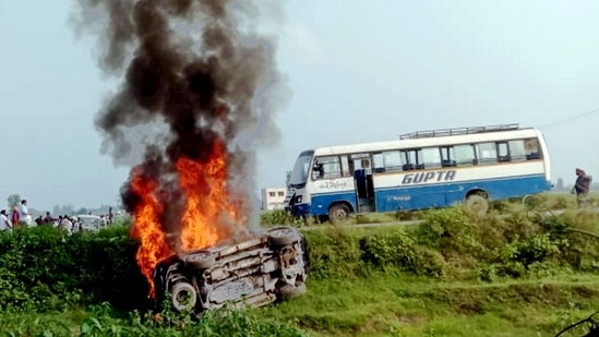 A vehicle is set ablaze after violence broke out following a farmers' protest in Lakhimpur Kheri.&nbsp;(PTI Photo)