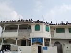 Students gather at the roof of Lal Masjid during an altercation with Pakistan security forces. (Twitter) Students gather at the roof of Lal Masjid during an altercation with Pakistan security forces. (Twitter)