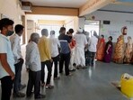 Voters stand in a queue to cast their votes during Gandhinagar Municipal Corporation elections, on Sunday.(PTI Photo)