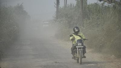 A motorist on the Masuri Bhool Garhi Road in Ghaziabad on Tuesday. (Sakib Ali/HT photo)