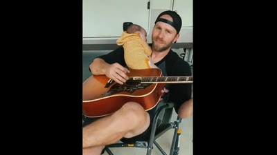 Dad strums guitar and sings a beautiful song for his adorable baby. Screengrab