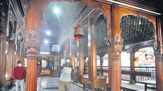A health worker sanitises a temple in Tulshibag on Tuesday, ahead of devotees being allowed in. Pune police patrols will remain watchful to avoid crowd gathering during the nine-day Navratri festival that starts from October 7. (HT)