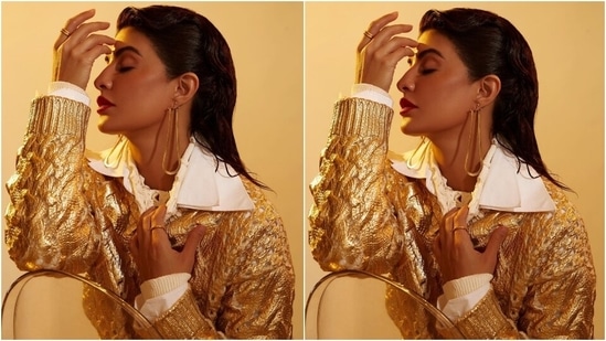 The Bhoot Police actor's attire for the TV show featured a wool knit sweater with laminated gold and ribbed pattern on the hem, collar and cuffs. The actor teamed the see-through jumper with a poplin white double-collared oversized shirt and a stretched high-neck top adorned with cut-outs.(Instagram/@jacquelinef143)