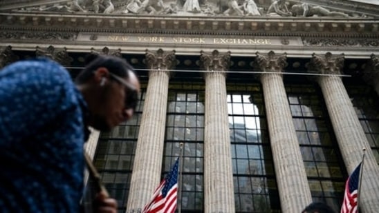 Pedestrians pass the New York Stock Exchange, Monday, Oct. 4, 2021, in the Manhattan borough of New York. (Representational Image)(AP) Pedestrians pass the New York Stock Exchange, Monday, Oct. 4, 2021, in the Manhattan borough of New York. (Representational Image)(AP)
