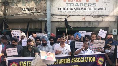 Industrialists protesting against steel price hike at the cycle market in Ludhiana on Wednesday. (HT Photo) Industrialists protesting against steel price hike at the cycle market in Ludhiana on Wednesday. (HT Photo)