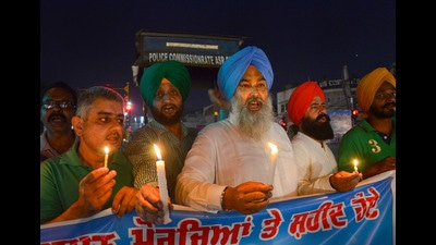 Folklore Research Academy members during a candle march over the Lakhimpur Kheri incident, in Amritsar on Wednesday. (PTI) Folklore Research Academy members during a candle march over the Lakhimpur Kheri incident, in Amritsar on Wednesday. (PTI)