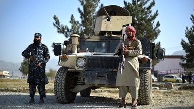 Taliban fighters working as a police force stand guard next to a Humvee vehicle at the entrance gate of a police district in Kabul.&nbsp; (File Photo / AFP)