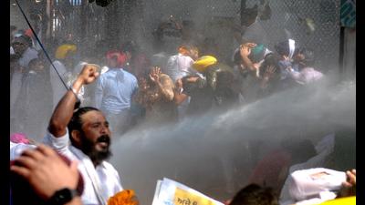 Chandigarh Police use water cannon to disperse AAP workers during the protest march against Lakhimpur Kheri incident at MLA on Wednesday. (Ravi Kumar/HT) Chandigarh Police use water cannon to disperse AAP workers during the protest march against Lakhimpur Kheri incident at MLA on Wednesday. (Ravi Kumar/HT)