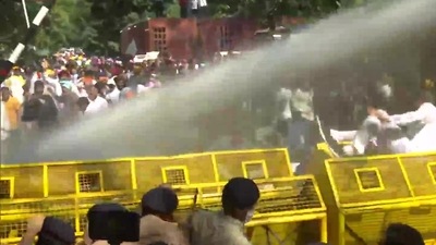 Aam Aadmi Party workers protest outside Raj Bhawan in Chandigarh over Lakhimpur Kheri violence, police use water cannon to disperse them. (ANI)
