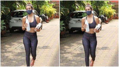 Malaika dressed up in a black sports bra with multiple uneven stripes of blue and pink. She paired it with a pair of yoga pants of the same print. The athleisure hugged her body at the right places and perfectly showed off her curves. For footwear, she opted for a comfy pair of pink flip-flops. (HT Photos/Varinder Chawla)