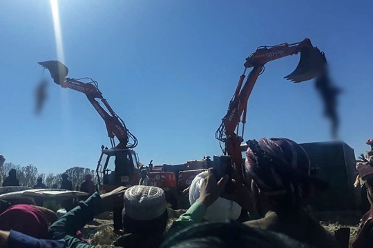 Two men, believed to be criminals, were hanged from excavators in Herat.(AFP Photo)