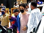 Aryan Khan, arrested in drugs case, being escorted at the NCB office after a medical check-up, in Mumbai on Wednesday. Aryan Khan, arrested in drugs case, being escorted at the NCB office after a medical check-up, in Mumbai on Wednesday.