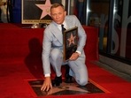 Daniel Craig poses atop his new star on the Hollywood Walk of Fame.