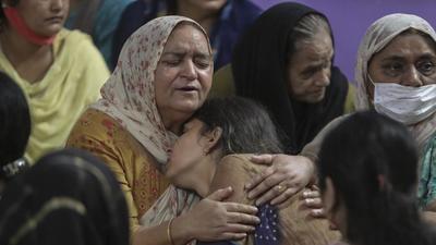 Relatives of Deepak Chand, the school teacher killed by terrorists on Thursday, mourn at their residence, in Jammu and Kashmir. School principal Satinder Kour was also killed in the terrorist attack. (AP) Relatives of Deepak Chand, the school teacher killed by terrorists on Thursday, mourn at their residence, in Jammu and Kashmir. School principal Satinder Kour was also killed in the terrorist attack. (AP)