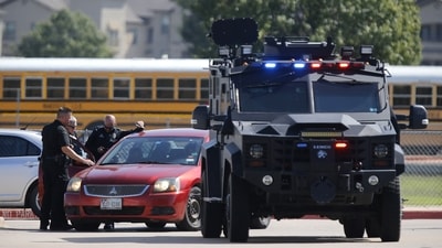 Emergency personnel work the scene in the parking lot at Timberview High School after a shooting on campus on October 6, 2021, in Arlington, Texas. (AFP) Emergency personnel work the scene in the parking lot at Timberview High School after a shooting on campus on October 6, 2021, in Arlington, Texas. (AFP)