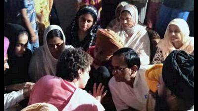 Congress General Secretary Priyanka Gandhi Vadra meets the family members of the Lakhimpur Kheri violence victim, Daljit Singh, at Banjaran Tanda village in Bahraich district, Thursday. (PTI Photo)