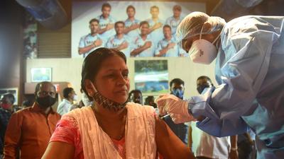 A healthcare worker inoculates a beneficiary against Covid-19 during a free vaccination camp at Shahaji Raje Sports Complex, Andheri (West), in Mumbai. (HT PHOTO) A healthcare worker inoculates a beneficiary against Covid-19 during a free vaccination camp at Shahaji Raje Sports Complex, Andheri (West), in Mumbai. (HT PHOTO)