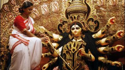 A woman decorates an idol of Goddess Durga ahead of Durga Puja festival in Kolkata. (ANI PHOTO.) A woman decorates an idol of Goddess Durga ahead of Durga Puja festival in Kolkata. (ANI PHOTO.)