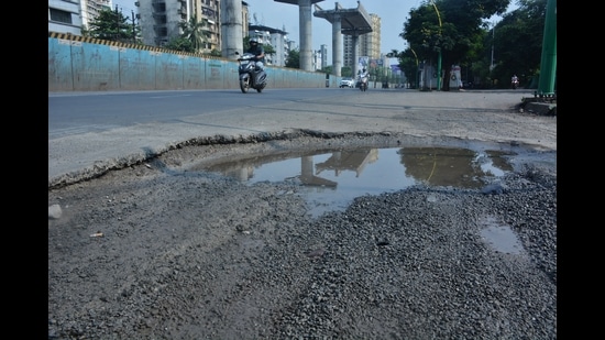 A pothole-ridden road on Ghodbunder Road in Thane on Thursday. Authorities have started the task of filling potholes and repairing roads in Thane. However, sudden showers on 2 days affected the road repair work. (PRAFUL GANGURDE/HT PHOTO) A pothole-ridden road on Ghodbunder Road in Thane on Thursday. Authorities have started the task of filling potholes and repairing roads in Thane. However, sudden showers on 2 days affected the road repair work. (PRAFUL GANGURDE/HT PHOTO)