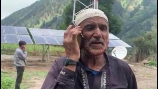 A man in Kishtwar’s Marwah valley talks on mobile phone as the region gets cellular connectivity. (HT Photo)