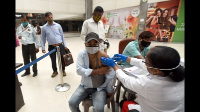 A person gets inoculated at a special drive-through Covid vaccination centre at the GIP Mall in Noida on Friday. (Sunil Ghosh/HT) A person gets inoculated at a special drive-through Covid vaccination centre at the GIP Mall in Noida on Friday. (Sunil Ghosh/HT)