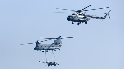 An Indian Air Force (IAF) Chinook helicopter carries an artillery gun alongside a MI-17 helicopter during the Air Force Day Parade at Hindon Air Force Station in Ghaziabad. (Bloomberg) An Indian Air Force (IAF) Chinook helicopter carries an artillery gun alongside a MI-17 helicopter during the Air Force Day Parade at Hindon Air Force Station in Ghaziabad. (Bloomberg)
