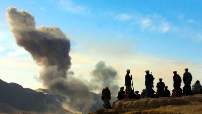 Northern Alliance soldiers watch as US air strikes attack Taliban positions in Kunduz province, Afghanistan. (AP)