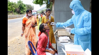 A medic takes swab samples for Covid-19 test of people entering Tamil Nadu from Andhra Pradesh state border at Christianpet check post in Vellore district on April 20, 2021. (PTI)
