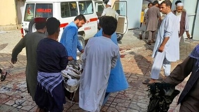 People carry the body of a bombing victim in Kunduz province, northern Afghanistan. (AP) People carry the body of a bombing victim in Kunduz province, northern Afghanistan. (AP)
