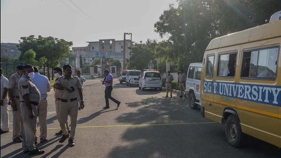 Police personnel inspect the spot of the shooting at SGT University campus in Gurugram on Friday. (HT PHOTO)