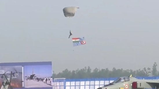 One of the three paratroopers is seen landing at the Hindon Air Force base during 89th IAF Day celebrations.(ANI Photo)