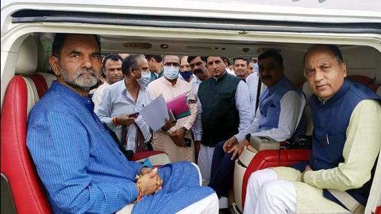 Chief minister Jai Ram Thakur with BJP state vice-president Kripal Parmar (left) at Rehan in Fatehpur assembly segment before they flew to Jubbal-Kotkhai on the last day of filing nominations on Friday for the October 30 byelection. (HT Photo)