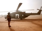 A French soldier stands guards in front of an NH90 Caiman military helicopter during Operation Barkhane in Mali.&nbsp;