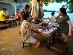 Flood dining at a riverside restaurant becomes a hit among tourists in Thailand(AP) Flood dining at a riverside restaurant becomes a hit among tourists in Thailand(AP)