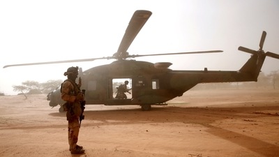 A French soldier stands guards in front of an NH90 Caiman military helicopter during Operation Barkhane in Mali.&nbsp; (File Photo / REUTERS)