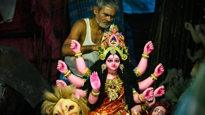 In this photos, an artist from Mumbai fixes Goddess Durga's hair and crown ahead of Durga Puja festival at a workshop in Vashi, Navi Mumbai. (PTI) In this photos, an artist from Mumbai fixes Goddess Durga's hair and crown ahead of Durga Puja festival at a workshop in Vashi, Navi Mumbai. (PTI)