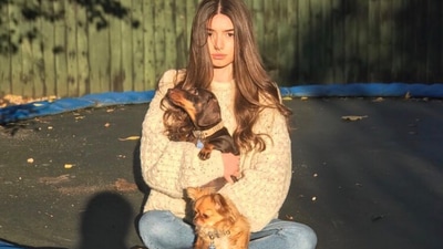 Mimi is seen posing with her dogs in this photo. Mimi is seen posing with her dogs in this photo.