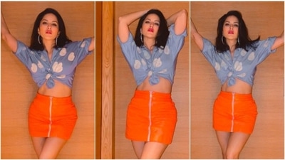 Sunny Leone, who never fails to impress the fashion police with her sartorial choices, shared a few photos of herself in a cropped blue shirt and an orange skirt. (Instagram/@sunnyleone) Sunny Leone, who never fails to impress the fashion police with her sartorial choices, shared a few photos of herself in a cropped blue shirt and an orange skirt. (Instagram/@sunnyleone)