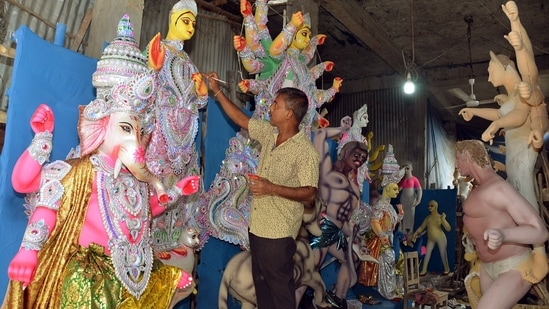 An artist in Assam's Tezpur gives final touches to an idol of Goddess Durga. (ANI)