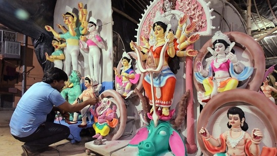 In this photo, an artist can be seen giving final touches to an idol of Goddess Durga for the upcoming Durga Puja festival, at Chittaranjan Park, New Delhi.(ANI)