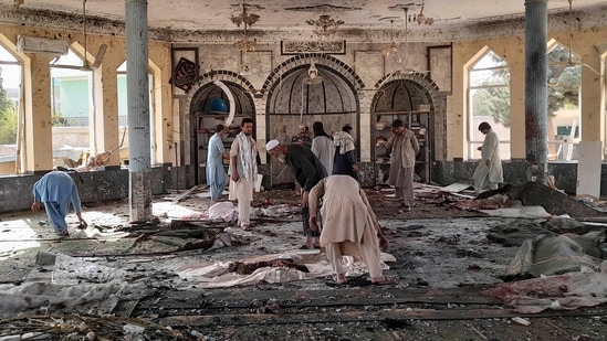 People view the damage inside of a mosque following a bombing in Kunduz, province northern Afghanistan, on Friday, October. 8, 2021. (AP) People view the damage inside of a mosque following a bombing in Kunduz, province northern Afghanistan, on Friday, October. 8, 2021. (AP)