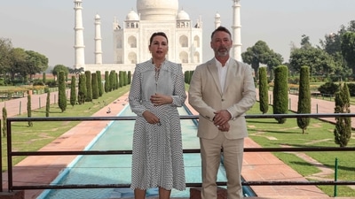 Denmark's Prime Minister Mette Frederiksen (L) poses for pictures along with her husband as they visit the Taj Mahal in Agra on October 10, 2021. (Photo by Pawan SHARMA / AFP) (AFP)